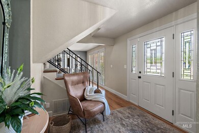 Entryway with wood finished floors and stairway