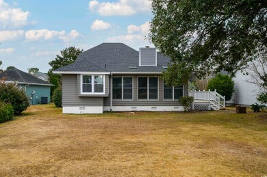 Rear view of house with central AC, a yard, and a 
