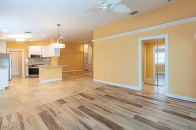 Kitchen with ceiling fan, stainless steel applianc