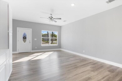 Entryway with ceiling fan and light hardwood / wood-style flooring