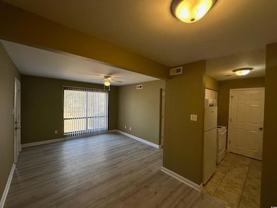 Interior space with ceiling fan, wood-type floorin