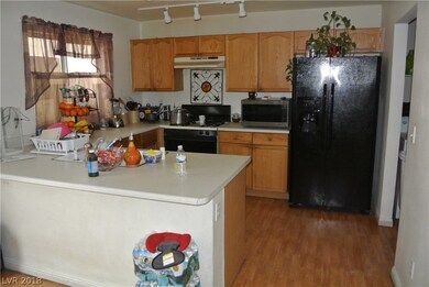 Kitchen with Sold Countertops and Track Lighting