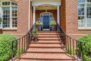 Entrance with brick steps and columns.