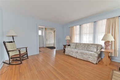 Large window in living room and original hardwood