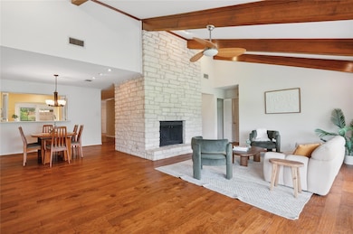Living room featuring visible vents, wood finishe