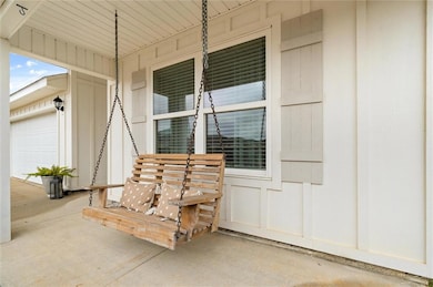 Doorway to property featuring covered porch and a 