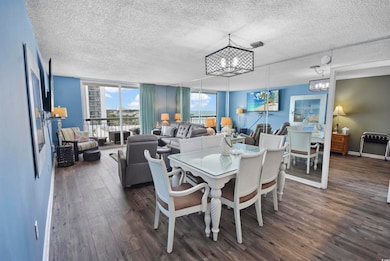 Dining area featuring an inviting chandelier, a te