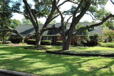 This charming home is accented by beautiful oaks.