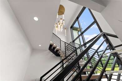 Stairway with a high ceiling, recessed lighting, and healthy amount of natural light