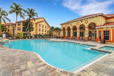 Pool featuring a patio, fence, and a hot tub