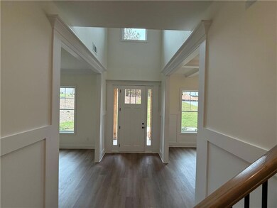 Entrance foyer with crown molding and wainscoting.