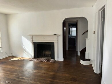 Unfurnished living room with dark hardwood / wood-style flooring