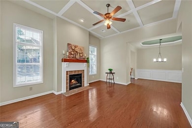 Spacious, open concept living area with coffered ceiling.