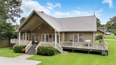 View of front facade featuring a wooden deck and a