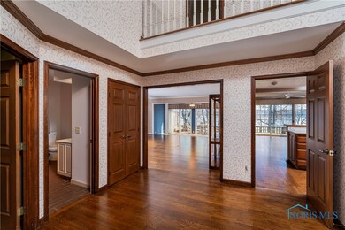 Entry With Elegant Hardwood Floors Seen Throughout