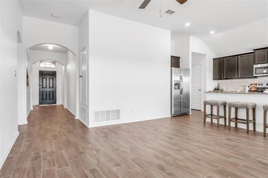 Wood-like tiles in the hallways, living areas and kitchen