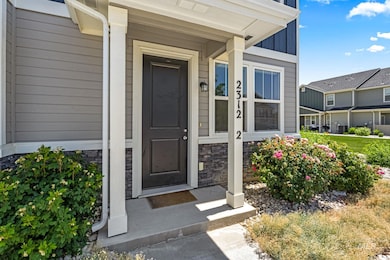 Entrance to property with stone siding and board and batten siding