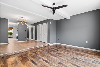 Interior space with beam ceiling, ceiling fan with