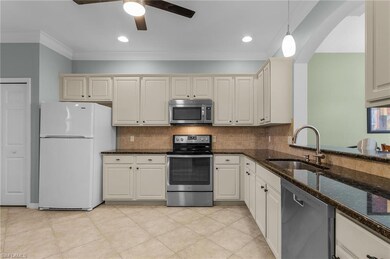 Kitchen featuring sink, dark stone countertops, or