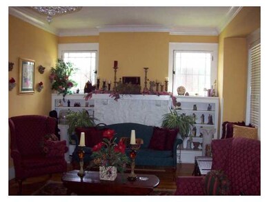 Living room boast a fireplace with bookcases on bo