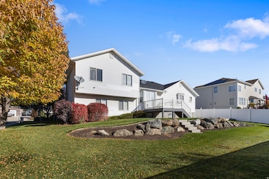 Rear view of house with stairway and a wooden deck