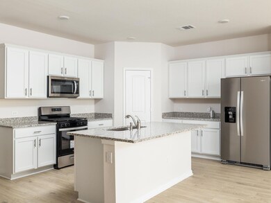 Kitchen with a sink, light wood-type flooring, ap