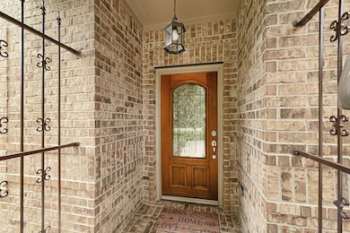 Charming covered front entry with wrought iron acc
