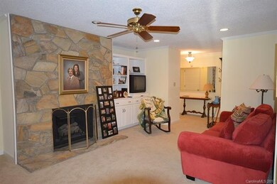 Living room with fireplace and built in cabinetry