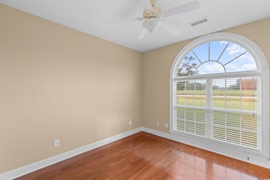 Empty room with ceiling fan and hardwood / wood-st