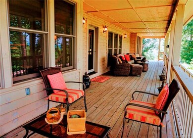 The far end of the large covered porch toward driv