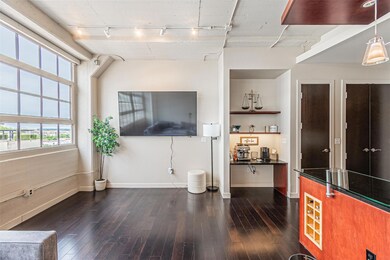 Living room with track lighting and dark wood-type
