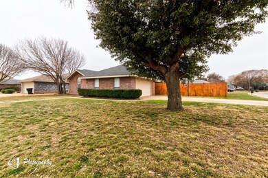 Single story home with a garage and a front yard