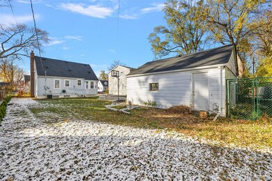 Rear view of property featuring a gate and a chimney