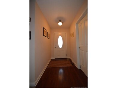Lovely foyer with hardwood flooring.  Door to the 