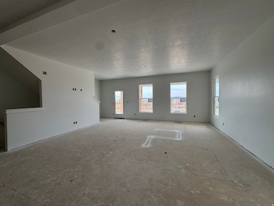 Unfurnished living room with a textured ceiling