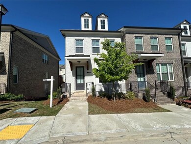 Townhome featuring brick siding