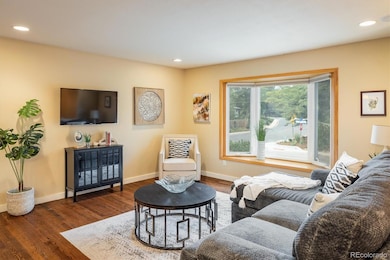 Light filled living room with a peak of the foothills.