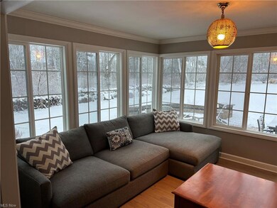 Family room with wall of windows overlooking the p