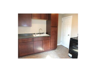 Remodeled kitchen with tile floor, new cabinets an