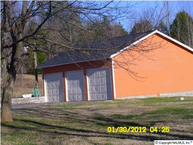 detached three car garage with new paint trim