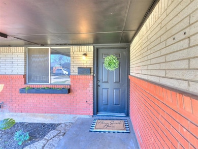 View of exterior entry with brick siding