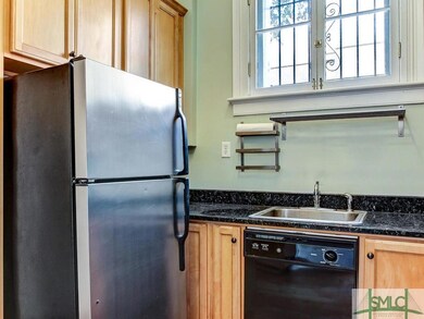 Kitchen with hardwood floor and fully equipped wit