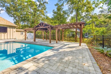 View of swimming pool with a patio and a pergola