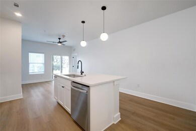 Kitchen with stainless steel dishwasher, a sink, 