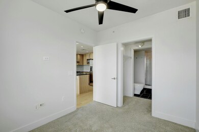 Unfurnished bedroom with baseboards, visible vent
