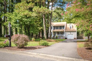 View of front of house featuring a garage and covered porch