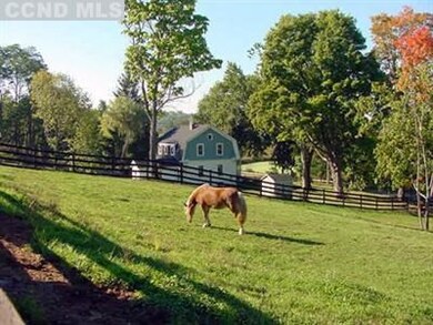 View from fenced paddock to farmhouse