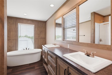 Full bath featuring a freestanding tub, wood fini