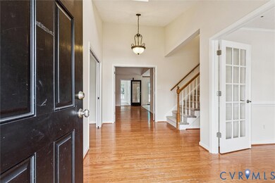 Foyer with light wood finished floors and stairway