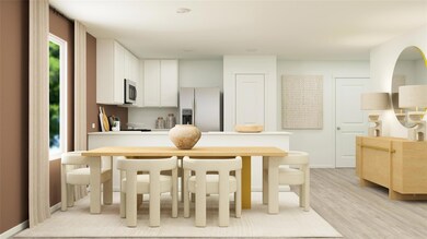 Kitchen featuring appliances with stainless steel finishes, white cabinets, and light wood-type flooring